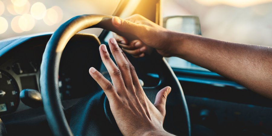 Angry driver honking horn to avoid crash.