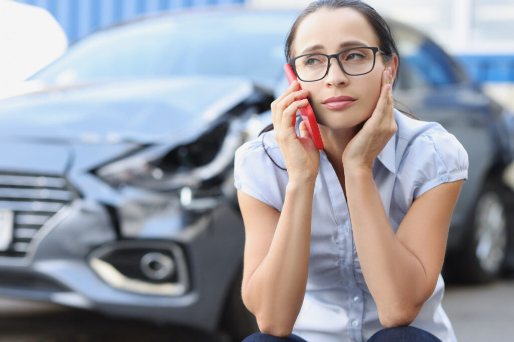 Woman calling help after an Uber accident.