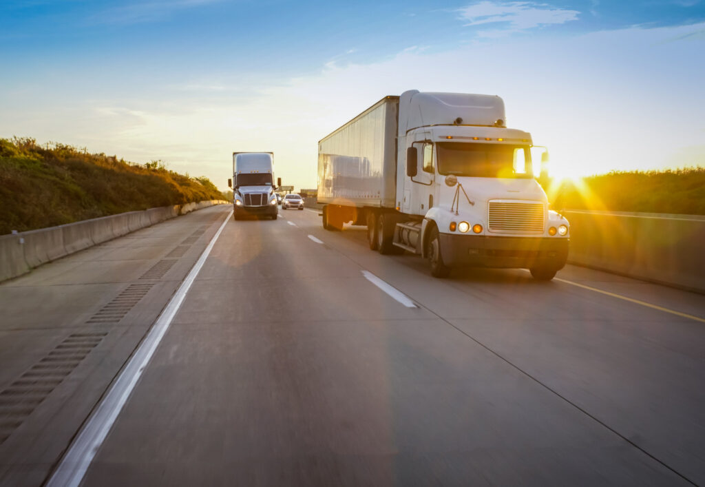 Trucks driving on 2 lane road.